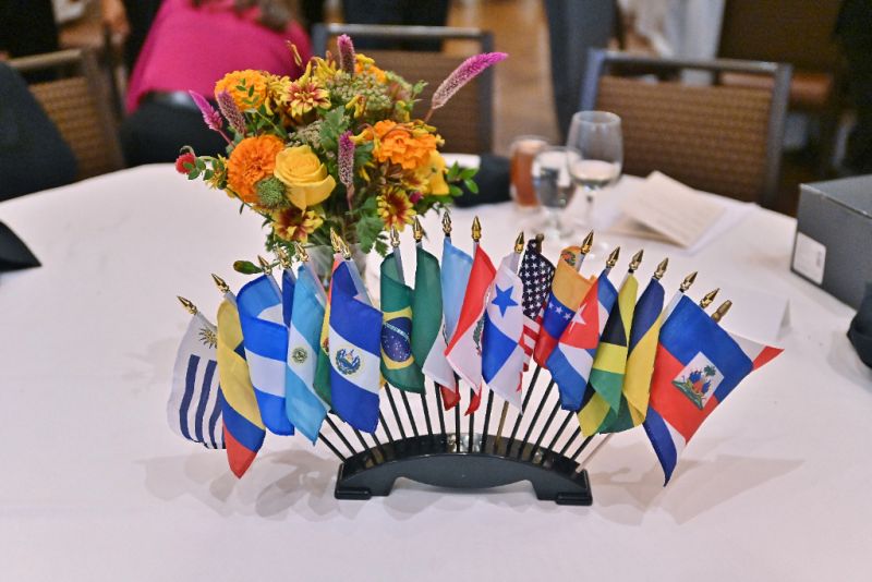 Decorative arrangement of small international flags in vase with flowers at Annual Members Meeting 2024